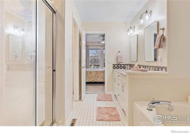 3000 E 112th Ave Unit 102, Northglenn, CO 80233 - ensuite bathroom featuring a shower stall, vanity, a garden tub, and tile patterned flooring