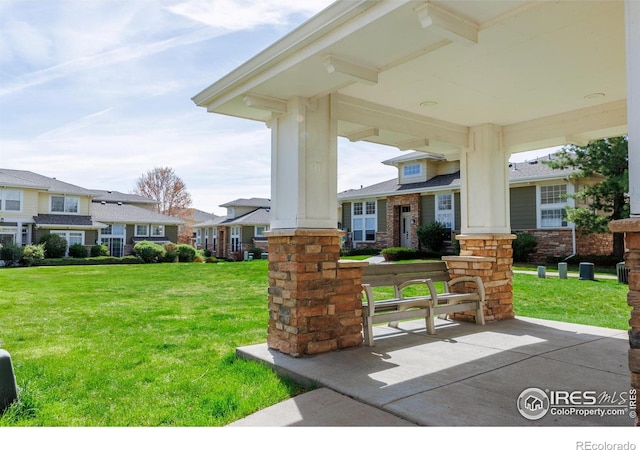 3000 E 112th Ave Unit 102, Northglenn, CO 80233 - covered porch featuring a lawn and a residential view