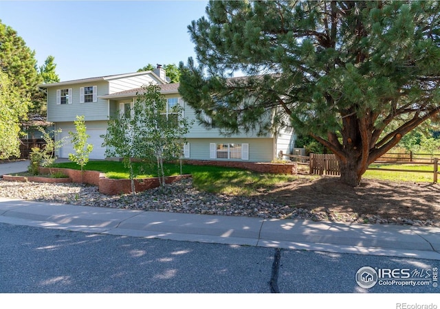 1305 Inverness Dr, Lafayette, CO 80026 - split level home with a chimney and a garage