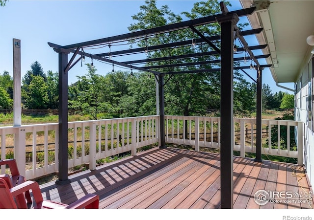 1305 Inverness Dr, Lafayette, CO 80026 - deck featuring a pergola and view of wooded area
