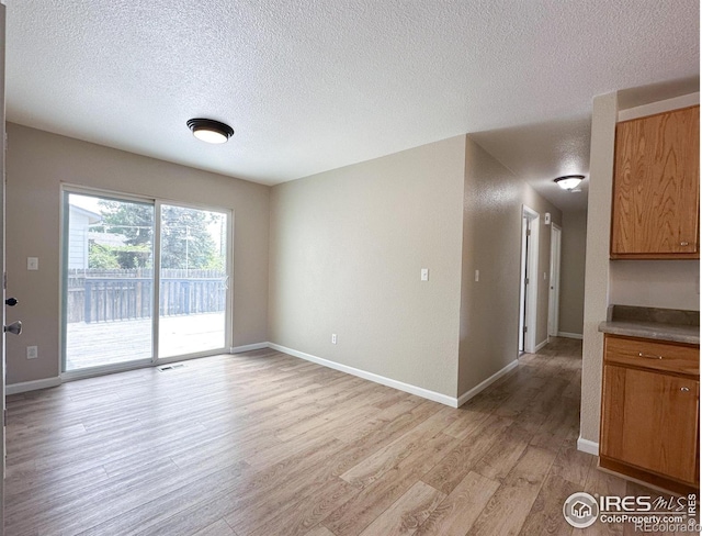 11941 S Clayson St, Parker, CO 80138 - unfurnished room featuring light wood-type flooring and a textured ceiling