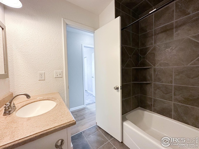 11941 S Clayson St, Parker, CO 80138 - full bathroom with vanity, tile patterned flooring, tub / shower combination, and a textured wall