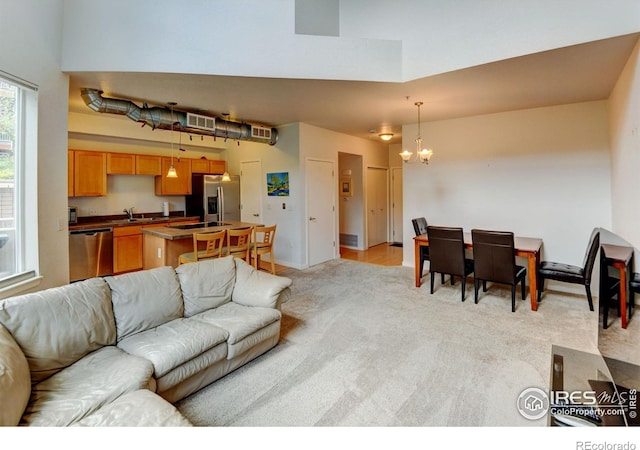 2850 E College Ave Unit 110, Boulder, CO 80303 - living area with light carpet and a chandelier