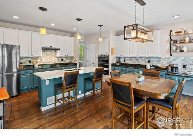 23570 E Holly Hills Way, Parker, CO 80138 - kitchen with black appliances, tasteful backsplash, blue cabinets, white cabinets, and recessed lighting