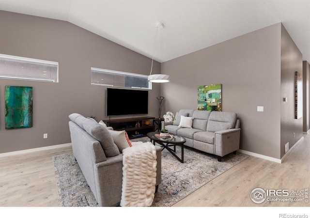 750 Kubat Ln Unit B, Longmont, CO 80503 - living room featuring wood finished floors and vaulted ceiling