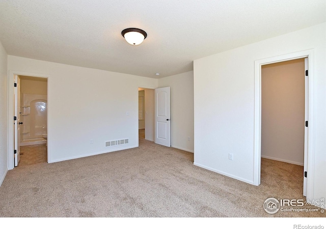 625 87th Ave, Greeley, CO 80634 - unfurnished bedroom with carpet flooring, a walk in closet, and ensuite bathroom