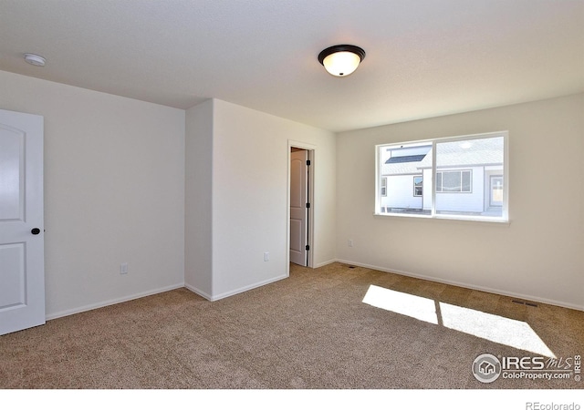 625 87th Ave, Greeley, CO 80634 - carpeted empty room with a smoke detector and baseboards
