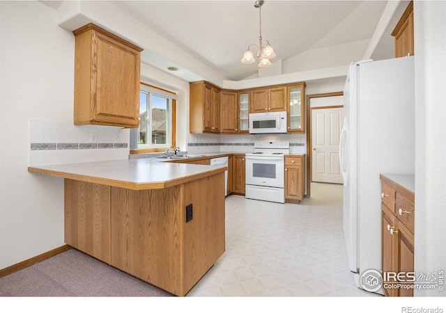 1754 45th Ave, Greeley, CO 80634 - kitchen featuring white appliances, a peninsula, lofted ceiling, light floors, and brown cabinets