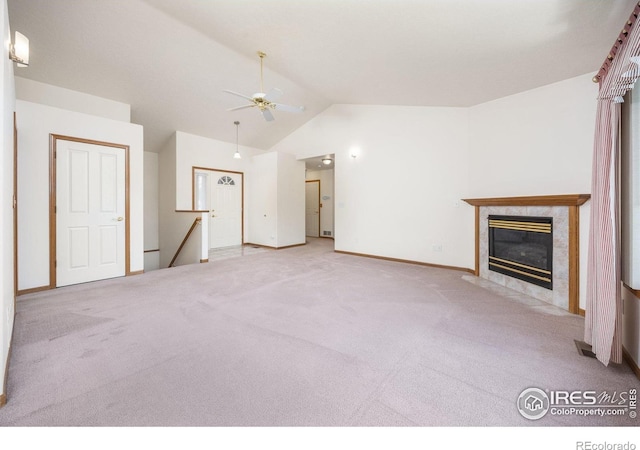 1754 45th Ave, Greeley, CO 80634 - unfurnished living room with vaulted ceiling, a ceiling fan, carpet flooring, and a fireplace