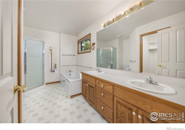 1754 45th Ave, Greeley, CO 80634 - full bathroom with a shower stall, double vanity, a garden tub, and tile patterned floors