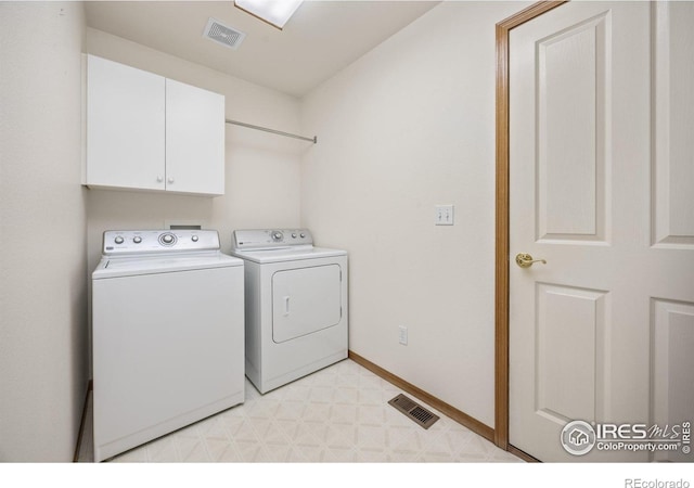 1754 45th Ave, Greeley, CO 80634 - washroom featuring cabinet space, washer and clothes dryer, and light flooring