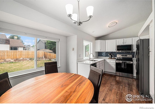 6019 S Pierson Ct, Littleton, CO 80127 - kitchen featuring appliances with stainless steel finishes, lofted ceiling, a chandelier, dark wood finished floors, and light countertops