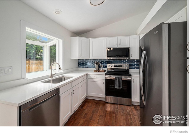 6019 S Pierson Ct, Littleton, CO 80127 - kitchen featuring appliances with stainless steel finishes, vaulted ceiling, dark wood finished floors, white cabinets, and decorative backsplash
