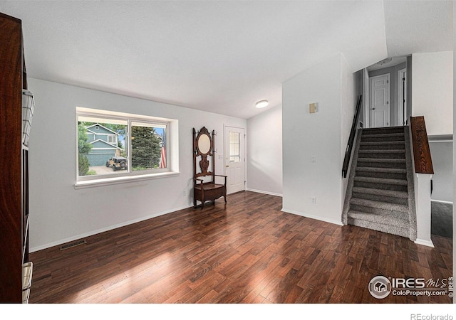 6019 S Pierson Ct, Littleton, CO 80127 - unfurnished living room with wood finished floors, stairway, and vaulted ceiling