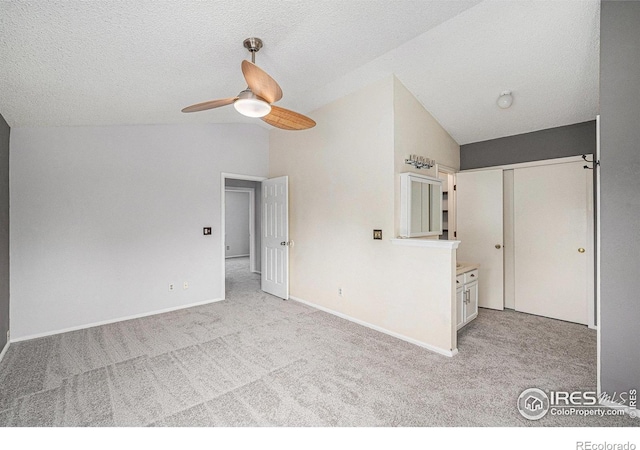 6019 S Pierson Ct, Littleton, CO 80127 - empty room featuring vaulted ceiling, light colored carpet, a ceiling fan, and a textured ceiling