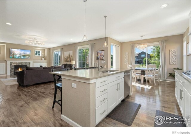 8541 Allenbrook Dr, Windsor, CO 80550 - kitchen with a chandelier, dishwasher, dark wood-style floors, white cabinets, and recessed lighting