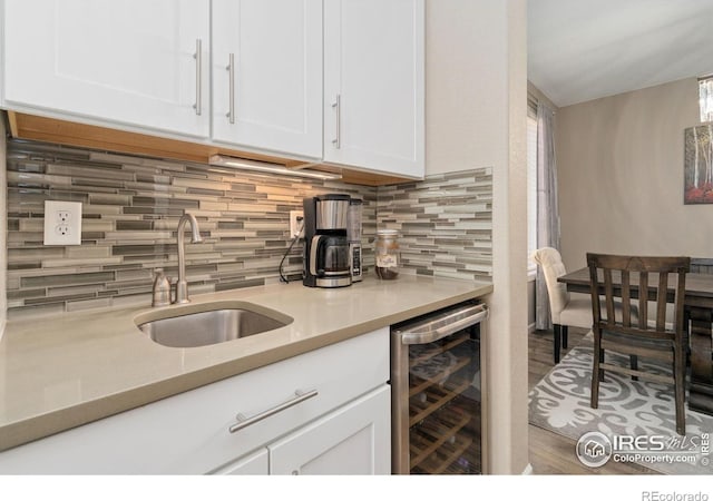 8541 Allenbrook Dr, Windsor, CO 80550 - kitchen featuring beverage cooler, white cabinets, decorative backsplash, and light countertops