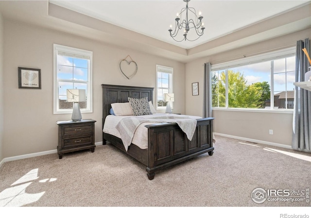 8541 Allenbrook Dr, Windsor, CO 80550 - carpeted bedroom with a raised ceiling and a chandelier