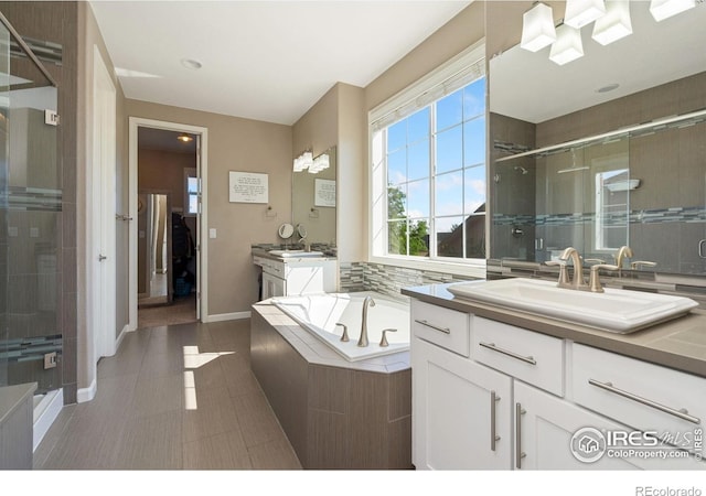 8541 Allenbrook Dr, Windsor, CO 80550 - bathroom with a shower stall, two vanities, a bath, and tile patterned flooring