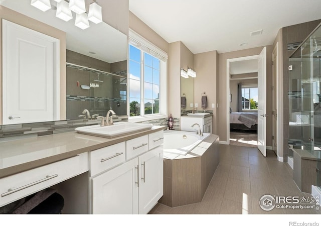 8541 Allenbrook Dr, Windsor, CO 80550 - bathroom featuring a stall shower, vanity, a bath, and ensuite bathroom