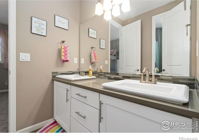 8541 Allenbrook Dr, Windsor, CO 80550 - bathroom featuring double vanity and baseboards