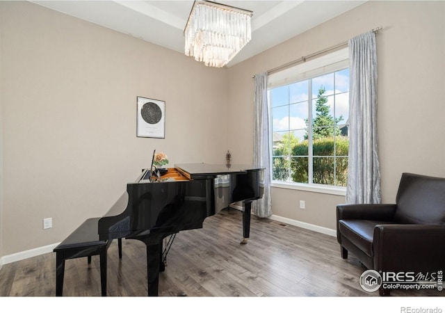 8541 Allenbrook Dr, Windsor, CO 80550 - sitting room featuring a chandelier and wood finished floors