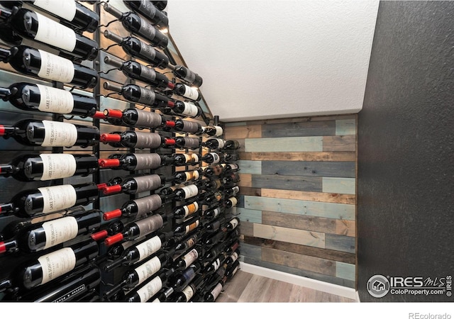 8541 Allenbrook Dr, Windsor, CO 80550 - wine room featuring wood finished floors and wooden walls