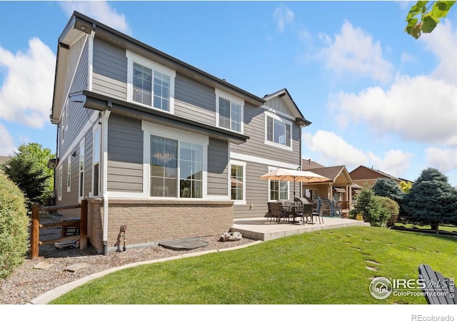 8541 Allenbrook Dr, Windsor, CO 80550 - rear view of property with brick siding, a patio, and a yard