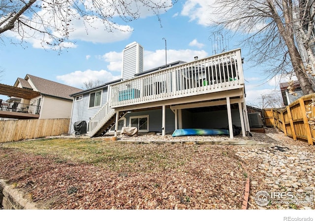 4644 W 112th Ct, Westminster, CO 80031 - back of house with stairway, a deck, a fenced backyard, and a chimney
