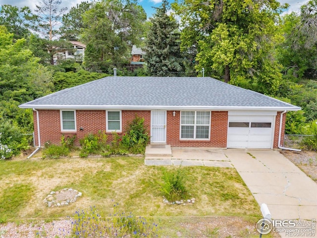 7637 Upham Ct, Arvada, CO 80003 - ranch-style house with a garage, a shingled roof, brick siding, and concrete driveway
