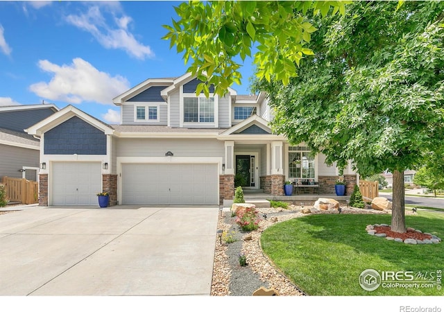 5355 Brookline Dr, Timnath, CO 80547 - craftsman inspired home with stone siding, concrete driveway, a front lawn, and an attached garage