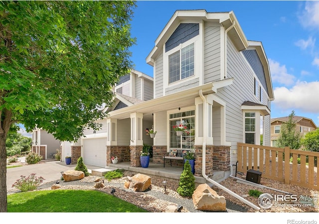5355 Brookline Dr, Timnath, CO 80547 - view of front of house featuring a porch, driveway, and a garage