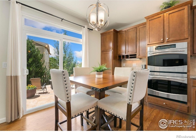 5355 Brookline Dr, Timnath, CO 80547 - dining space with a chandelier and light wood-style flooring