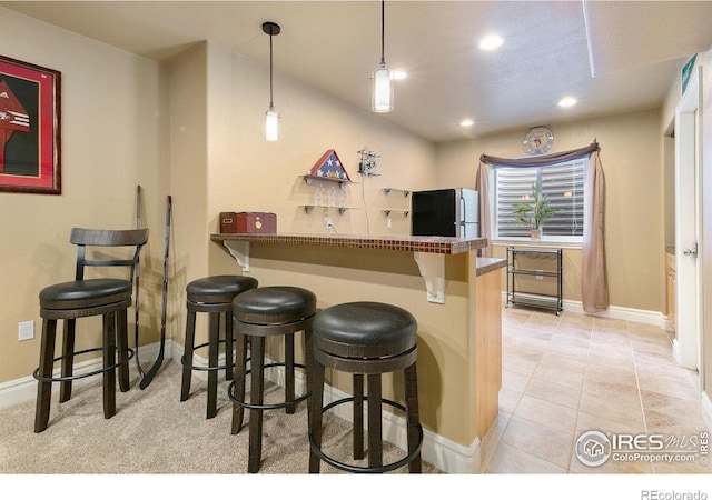 5355 Brookline Dr, Timnath, CO 80547 - bar area with freestanding refrigerator, recessed lighting, pendant lighting, and light tile patterned flooring