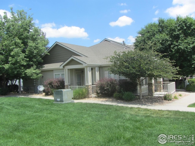1900 68th Ave Unit 701, Greeley, CO 80634 - craftsman house with covered porch, a front yard, and a shingled roof