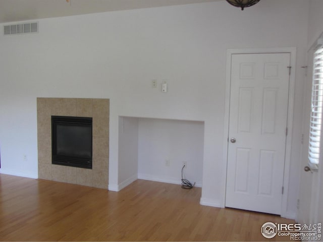 1900 68th Ave Unit 701, Greeley, CO 80634 - unfurnished living room with wood finished floors and a tiled fireplace