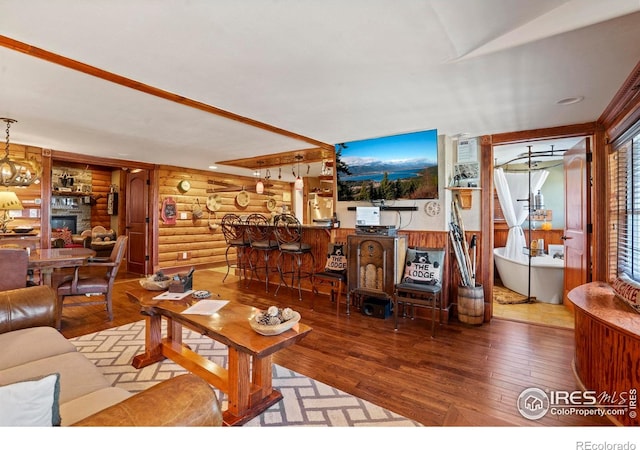 2238 Eagle Cliff Rd, Estes Park, CO 80517 - living area with rustic walls, hardwood / wood-style flooring, and a fireplace