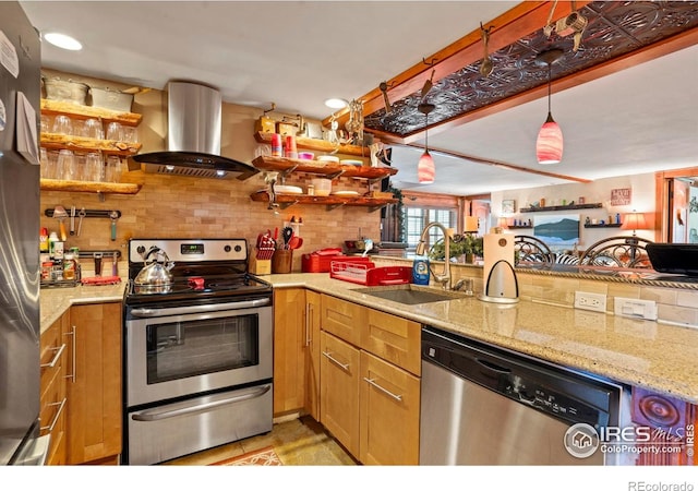 2238 Eagle Cliff Rd, Estes Park, CO 80517 - kitchen featuring stainless steel appliances, exhaust hood, backsplash, light stone counters, and decorative light fixtures