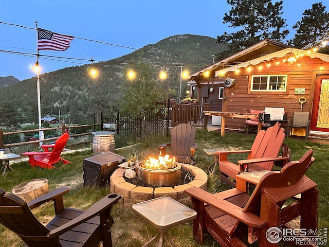 2238 Eagle Cliff Rd, Estes Park, CO 80517 - view of patio / terrace with an outdoor fire pit and a mountain view