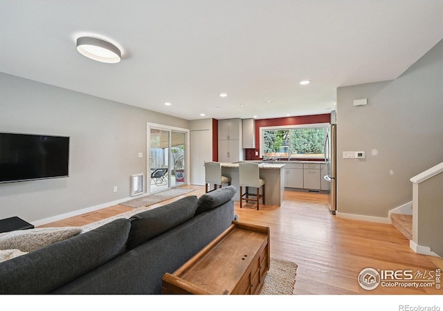 4655 Macky Way, Boulder, CO 80305 - living area featuring light wood finished floors, stairway, and recessed lighting