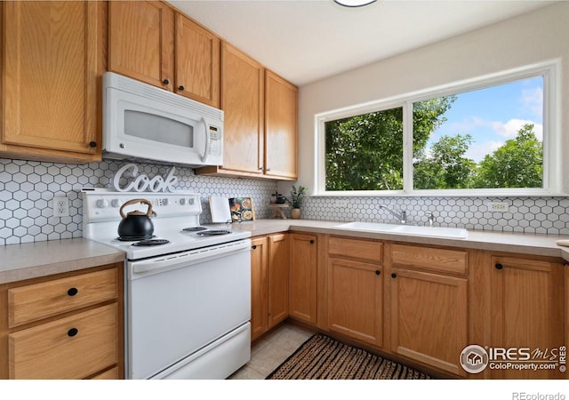 3350 Boulder Cir Unit 201, Broomfield, CO 80023 - kitchen with white appliances, light countertops, decorative backsplash, and light tile patterned floors