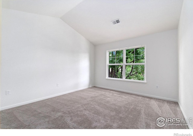 3350 Boulder Cir Unit 201, Broomfield, CO 80023 - carpeted spare room featuring vaulted ceiling and baseboards