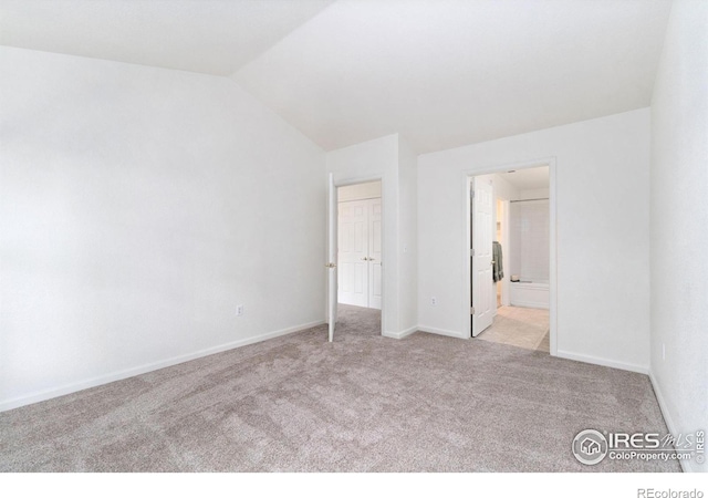3350 Boulder Cir Unit 201, Broomfield, CO 80023 - unfurnished bedroom with light colored carpet, vaulted ceiling, and ensuite bathroom