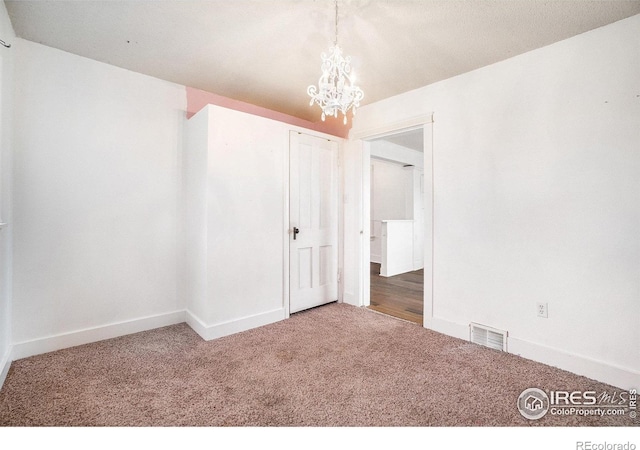 2118 N 47th Ave, Greeley, CO 80631 - empty room featuring carpet flooring and a chandelier