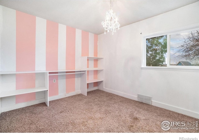2118 N 47th Ave, Greeley, CO 80631 - carpeted empty room featuring a chandelier and baseboards