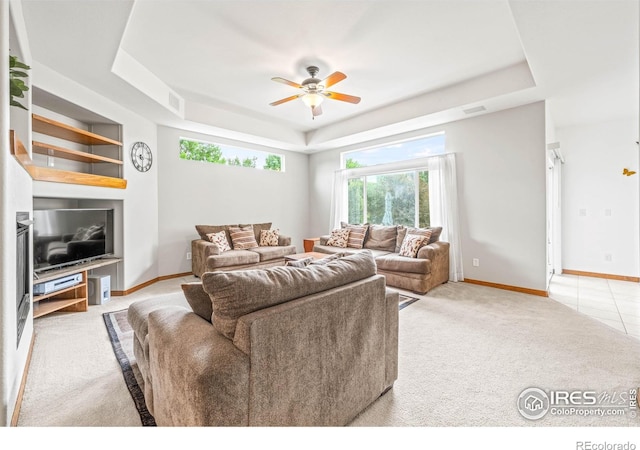 502 Peregrine Cir, Longmont, CO 80504 - living area featuring a raised ceiling, ceiling fan, and light carpet