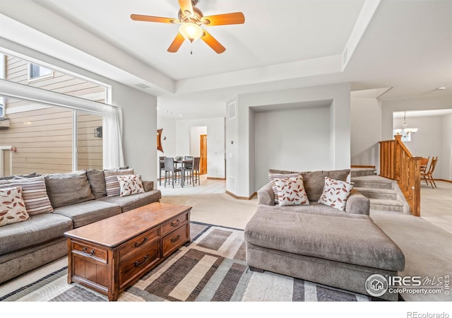 502 Peregrine Cir, Longmont, CO 80504 - living area with a chandelier, stairs, ceiling fan, and a tray ceiling