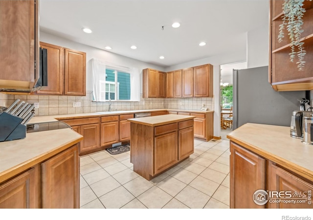 502 Peregrine Cir, Longmont, CO 80504 - kitchen with tasteful backsplash, light countertops, light tile patterned flooring, recessed lighting, and appliances with stainless steel finishes