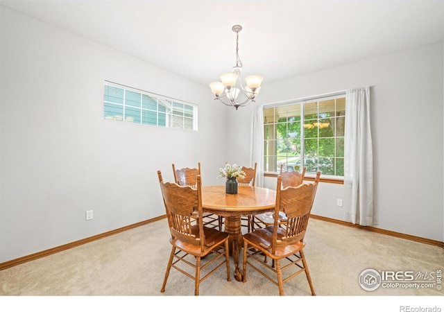 502 Peregrine Cir, Longmont, CO 80504 - dining room featuring a chandelier, plenty of natural light, and light carpet