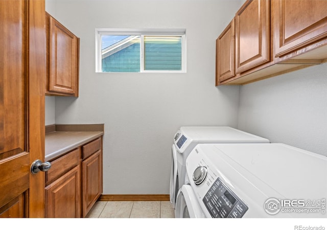 502 Peregrine Cir, Longmont, CO 80504 - laundry room featuring independent washer and dryer, cabinet space, and light tile patterned floors